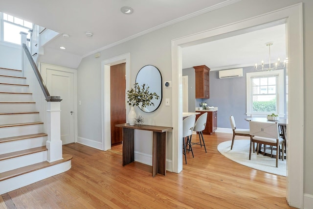 48 Faneuil Pl, New Rochelle, NY 10801 - foyer entrance featuring ornamental molding, stairs, light wood-type flooring, a chandelier, and a wall mounted air conditioner