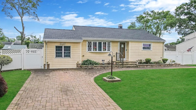10 Harrison St, Brentwood, NY 11717 - view of front of house with a gate, roof with shingles, and a patio area