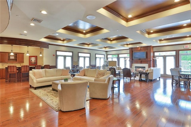 23 Bridge Ln Unit 23, Haverstraw, NY 10927 - living area featuring ornamental molding, hardwood / wood-style floors, a glass covered fireplace, and coffered ceiling