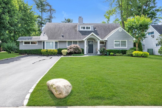 14 Ridge Dr E, Roslyn, NY 11576 - view of front facade featuring a front lawn, a chimney, and a shingled roof