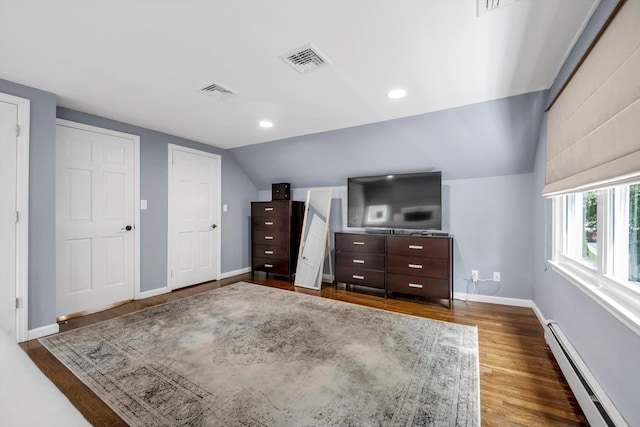14 Ridge Dr E, Roslyn, NY 11576 - unfurnished bedroom with a baseboard heating unit, lofted ceiling, and wood finished floors