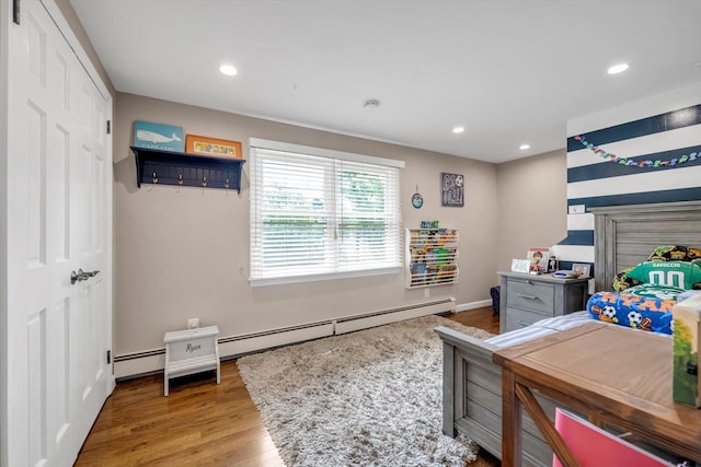 14 Ridge Dr E, Roslyn, NY 11576 - bedroom with recessed lighting, wood finished floors, and baseboard heating