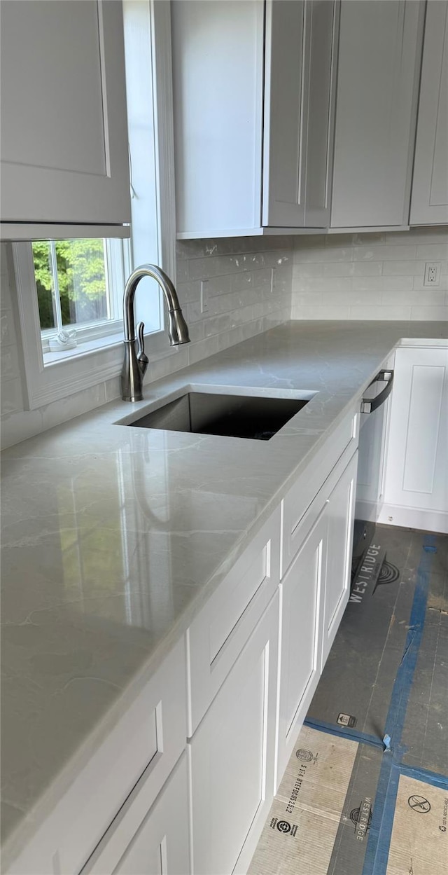 47 Sheridan Ave, Congers, NY 10920 - kitchen featuring decorative backsplash, white cabinetry, and light stone counters