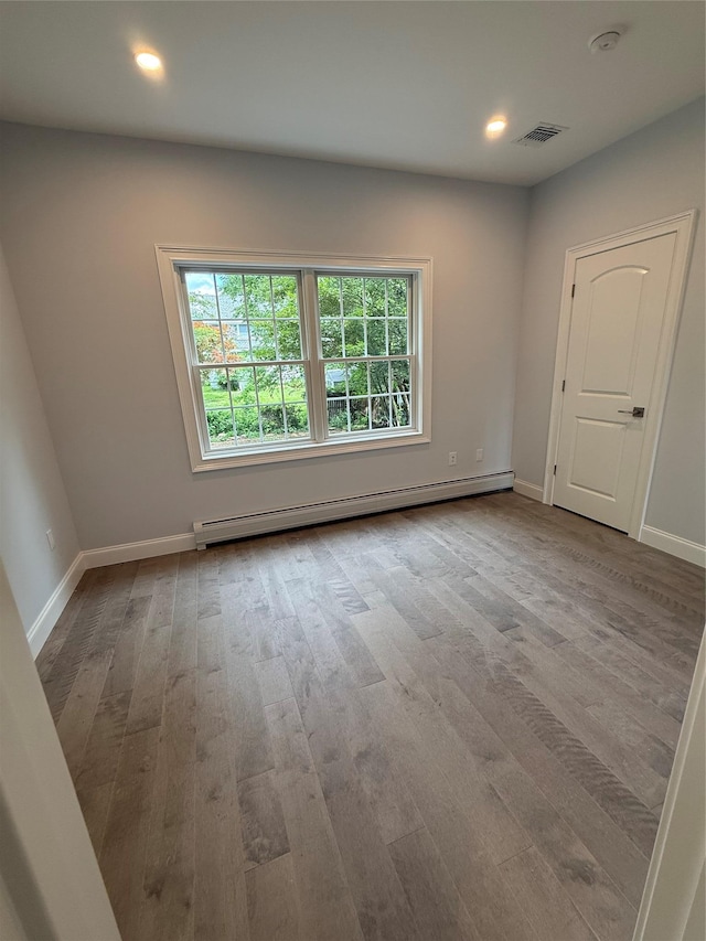 47 Sheridan Ave, Congers, NY 10920 - spare room featuring baseboard heating, healthy amount of natural light, wood finished floors, a smoke detector, and recessed lighting