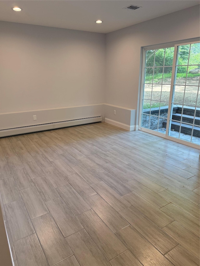 47 Sheridan Ave, Congers, NY 10920 - empty room with light wood finished floors, recessed lighting, and a baseboard heating unit