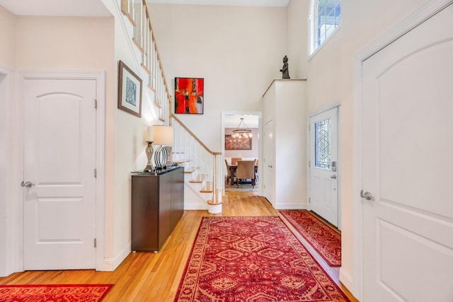 212A Lower Sheep Pasture Rd, East Setauket, NY 11733 - entrance foyer featuring light wood finished floors, stairway, and a high ceiling