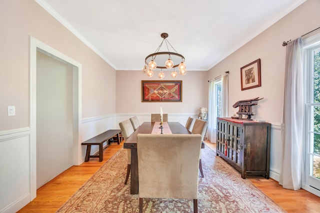 212A Lower Sheep Pasture Rd, East Setauket, NY 11733 - dining space with light wood-style floors, a chandelier, ornamental molding, and a baseboard radiator