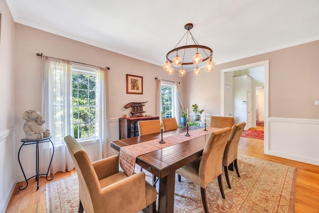 212A Lower Sheep Pasture Rd, East Setauket, NY 11733 - dining area featuring plenty of natural light, a chandelier, ornamental molding, and light wood finished floors