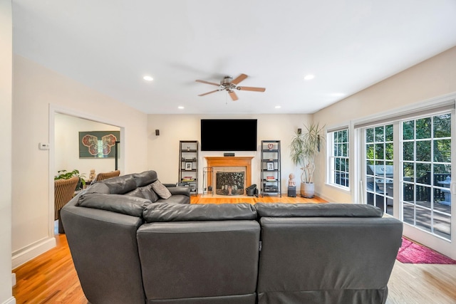 212A Lower Sheep Pasture Rd, East Setauket, NY 11733 - living room with light wood-type flooring, ceiling fan, a fireplace with flush hearth, and recessed lighting