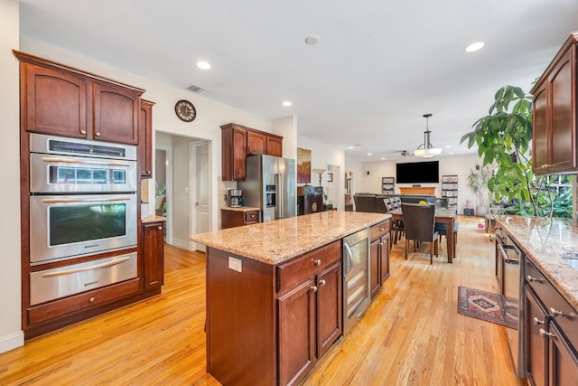 212A Lower Sheep Pasture Rd, East Setauket, NY 11733 - kitchen featuring stainless steel appliances, a warming drawer, beverage cooler, open floor plan, and light wood finished floors