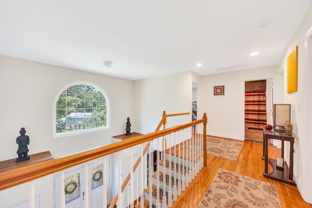 212A Lower Sheep Pasture Rd, East Setauket, NY 11733 - hall with an upstairs landing, light wood-style floors, and recessed lighting
