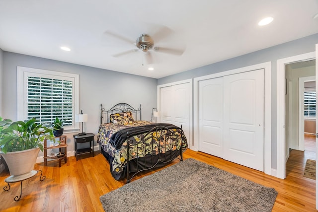 212A Lower Sheep Pasture Rd, East Setauket, NY 11733 - bedroom with multiple closets, light wood finished floors, multiple windows, recessed lighting, and ceiling fan