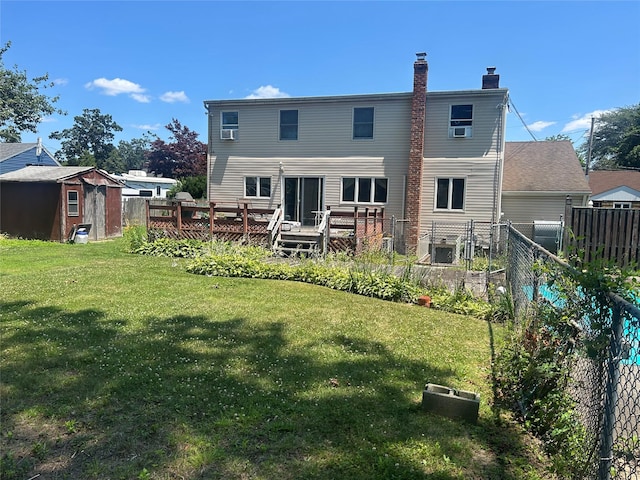 14 Eastwood Dr, North Babylon, NY 11703 - back of house with a shed, a wooden deck, a chimney, and a vegetable garden