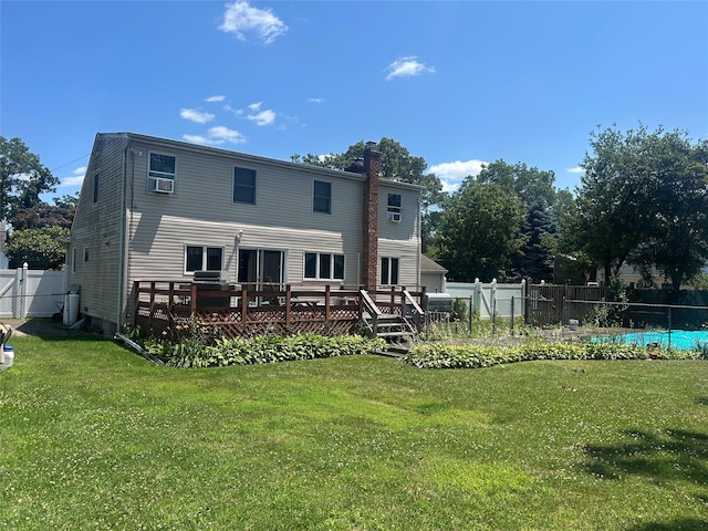 14 Eastwood Dr, North Babylon, NY 11703 - back of house featuring a wooden deck, a fenced backyard, and a chimney