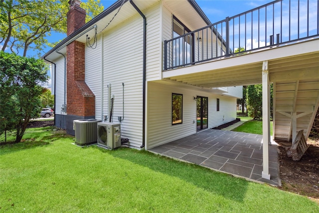 43 Acorn Ln, Plainview, NY 11803 - rear view of property featuring a balcony, a yard, a patio area, and a chimney