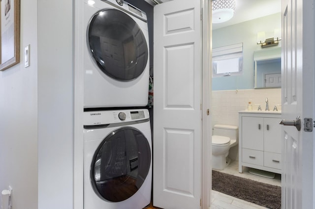 101 Connecticut Ave, Long Beach, NY 11561 - washroom with stacked washer / dryer, tile walls, and wainscoting