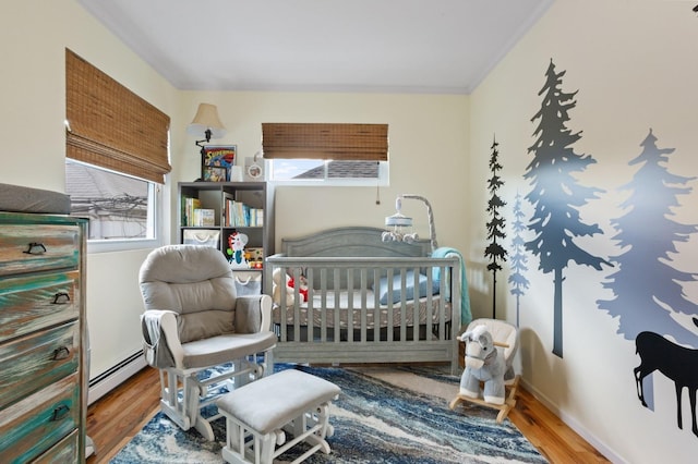 101 Connecticut Ave, Long Beach, NY 11561 - bedroom with a baseboard heating unit, wood finished floors, and crown molding