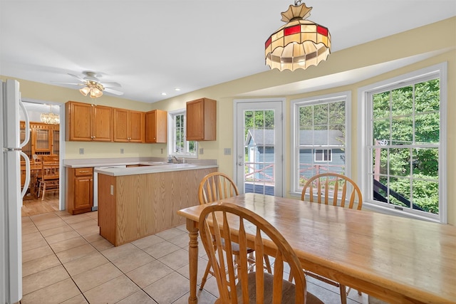 81 Hambletonian Rd, Chester, NY 10918 - kitchen featuring freestanding refrigerator, light tile patterned flooring, light countertops, a peninsula, and ceiling fan