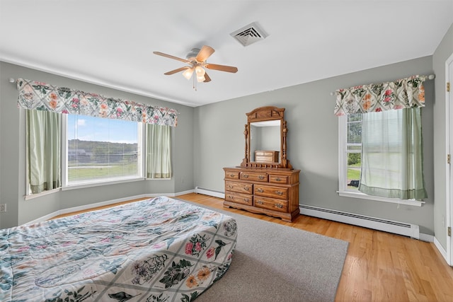 81 Hambletonian Rd, Chester, NY 10918 - bedroom with baseboard heating, light wood-style floors, and ceiling fan
