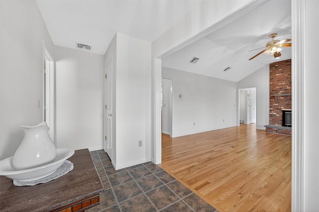 81 Hambletonian Rd, Chester, NY 10918 - unfurnished living room featuring vaulted ceiling, ceiling fan, and a brick fireplace