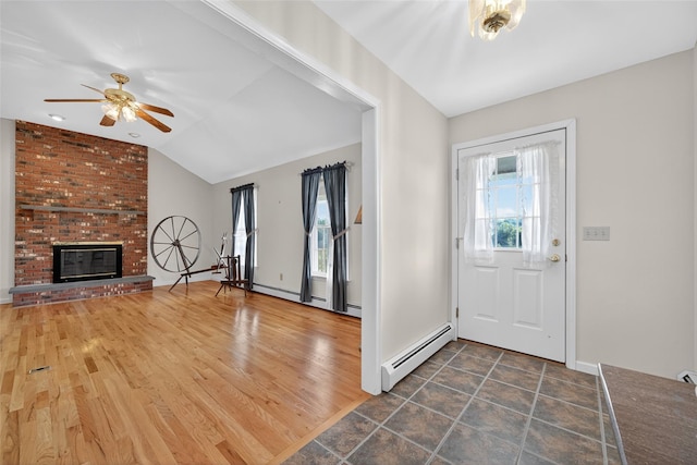 81 Hambletonian Rd, Chester, NY 10918 - entrance foyer with baseboard heating, a ceiling fan, lofted ceiling, and a fireplace