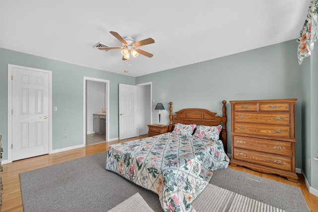 81 Hambletonian Rd, Chester, NY 10918 - bedroom featuring wood finished floors, ensuite bath, and a ceiling fan