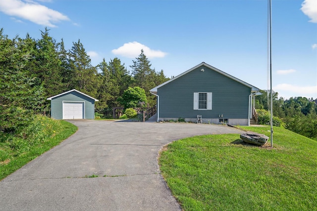 81 Hambletonian Rd, Chester, NY 10918 - view of home's exterior featuring an outdoor structure, a detached garage, a lawn, and driveway