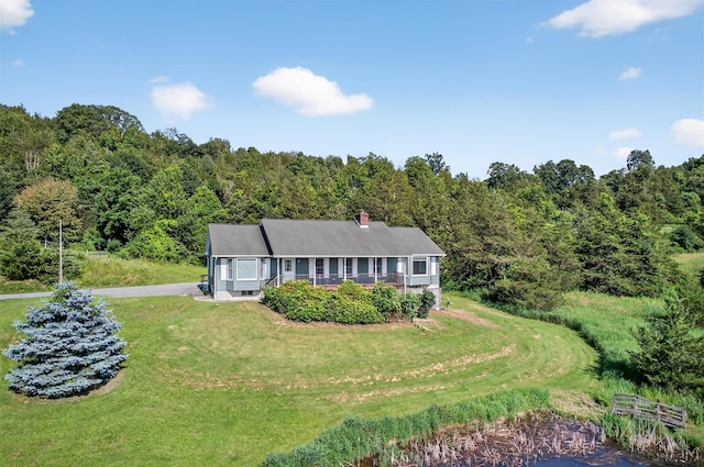 81 Hambletonian Rd, Chester, NY 10918 - view of front of home featuring a front lawn, a forest view, and a chimney
