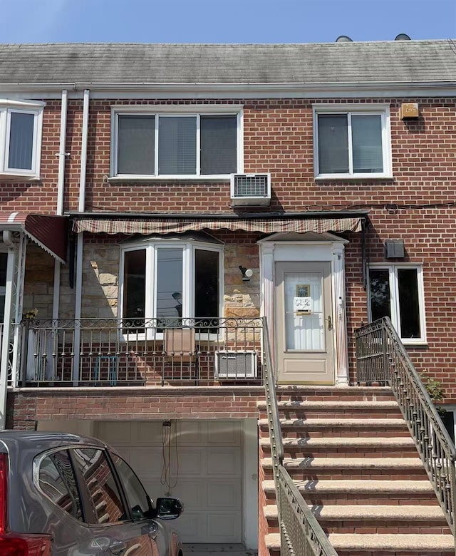 61-56 70th St, Middle Village, NY 11379 - view of property featuring an attached garage, brick siding, and a shingled roof