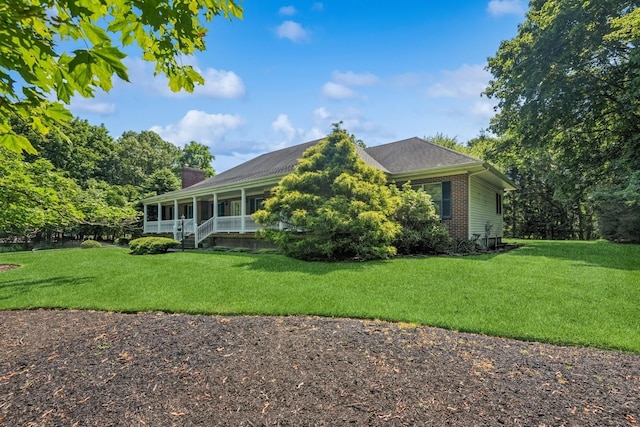 4 Springview Ct, East Patchogue, NY 11772 - view of front facade with brick siding, a sunroom, a front lawn, and a chimney