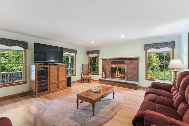 4 Springview Ct, East Patchogue, NY 11772 - living area featuring crown molding, light wood-type flooring, plenty of natural light, a brick fireplace, and recessed lighting