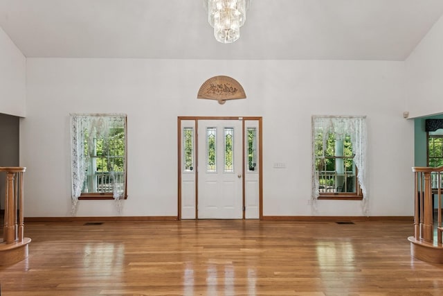 4 Springview Ct, East Patchogue, NY 11772 - foyer with wood finished floors and a chandelier