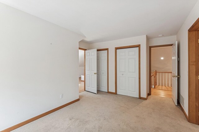 4 Springview Ct, East Patchogue, NY 11772 - unfurnished bedroom with multiple closets and light colored carpet