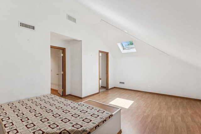 4 Springview Ct, East Patchogue, NY 11772 - unfurnished bedroom featuring a skylight, light wood finished floors, and lofted ceiling