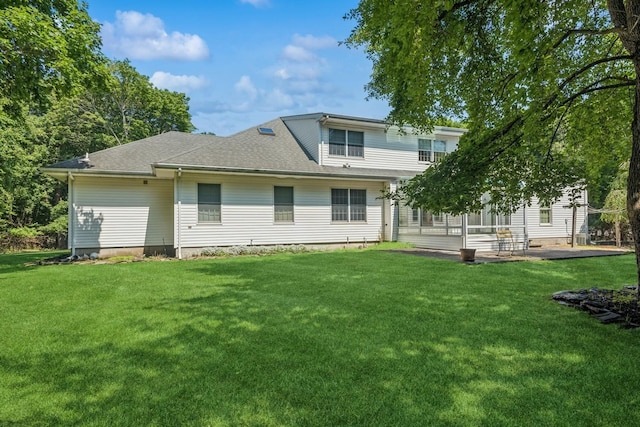 4 Springview Ct, East Patchogue, NY 11772 - back of property featuring a lawn, a shingled roof, and a patio