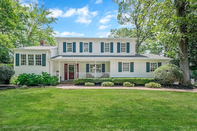 7 Simon Ct, East Northport, NY 11731 - view of front of house with covered porch, a front lawn, and a chimney