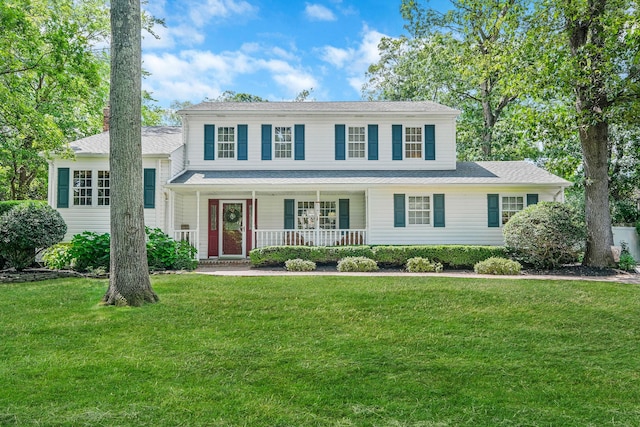 7 Simon Ct, East Northport, NY 11731 - view of front of home featuring covered porch, a front yard, and a chimney