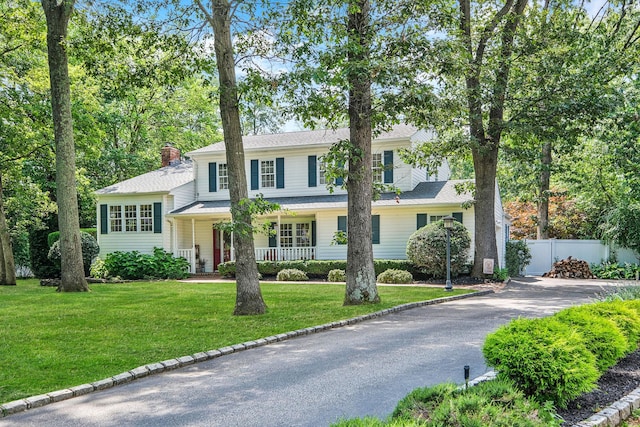 7 Simon Ct, East Northport, NY 11731 - view of front of property featuring a porch, a chimney, and driveway