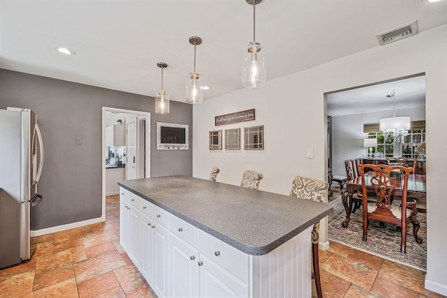 7 Simon Ct, East Northport, NY 11731 - kitchen featuring freestanding refrigerator, dark countertops, white cabinets, stone tile flooring, and recessed lighting