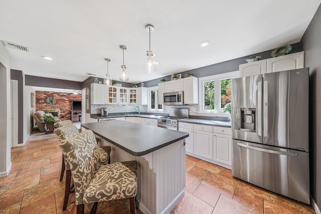 7 Simon Ct, East Northport, NY 11731 - kitchen featuring stainless steel appliances, glass insert cabinets, dark countertops, decorative backsplash, and white cabinetry
