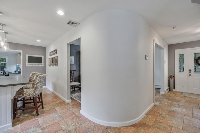 7 Simon Ct, East Northport, NY 11731 - foyer with stone tile floors, recessed lighting, and baseboard heating