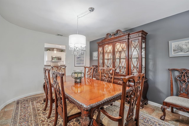 7 Simon Ct, East Northport, NY 11731 - dining area with a chandelier and light stone finish floors
