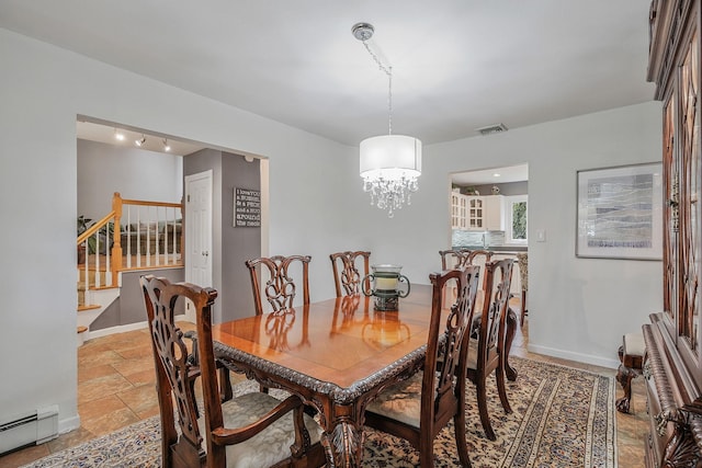 7 Simon Ct, East Northport, NY 11731 - dining area featuring a baseboard heating unit, stairway, stone tile flooring, and a chandelier