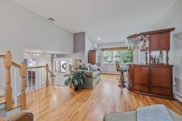 7 Simon Ct, East Northport, NY 11731 - living room with light wood-type flooring, baseboard heating, and stairs