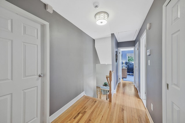 7 Simon Ct, East Northport, NY 11731 - hall with an upstairs landing, attic access, and light wood-style floors