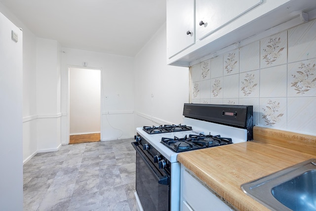 3850 Sedgwick Ave Unit 5B, Bronx, NY 10463 - kitchen with white range with gas cooktop, white cabinets, and light countertops