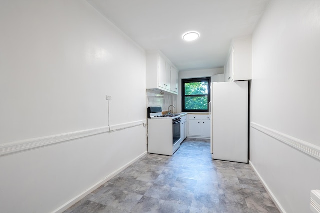 3850 Sedgwick Ave Unit 5B, Bronx, NY 10463 - kitchen featuring white appliances, white cabinets, stone finish floors, and decorative backsplash