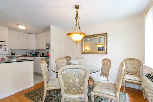 10 Canterbury Rd Apt 2G, Great Neck, NY 11021 - dining room with light wood-type flooring and baseboards