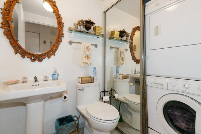 10 Canterbury Rd Apt 2G, Great Neck, NY 11021 - bathroom featuring stacked washer / drying machine and toilet