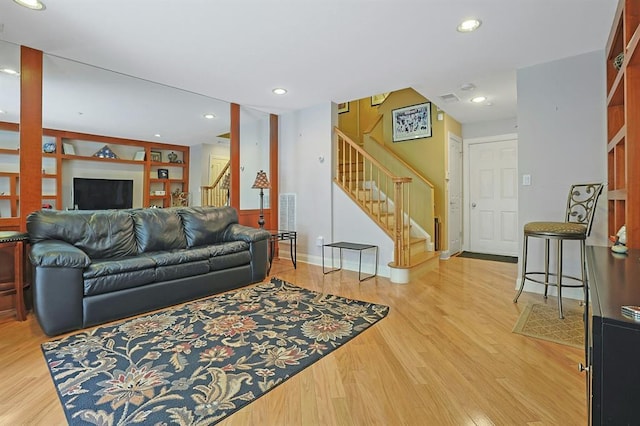 27 Bridge Ln, Haverstraw, NY 10927 - living area featuring stairs, wood finished floors, and recessed lighting